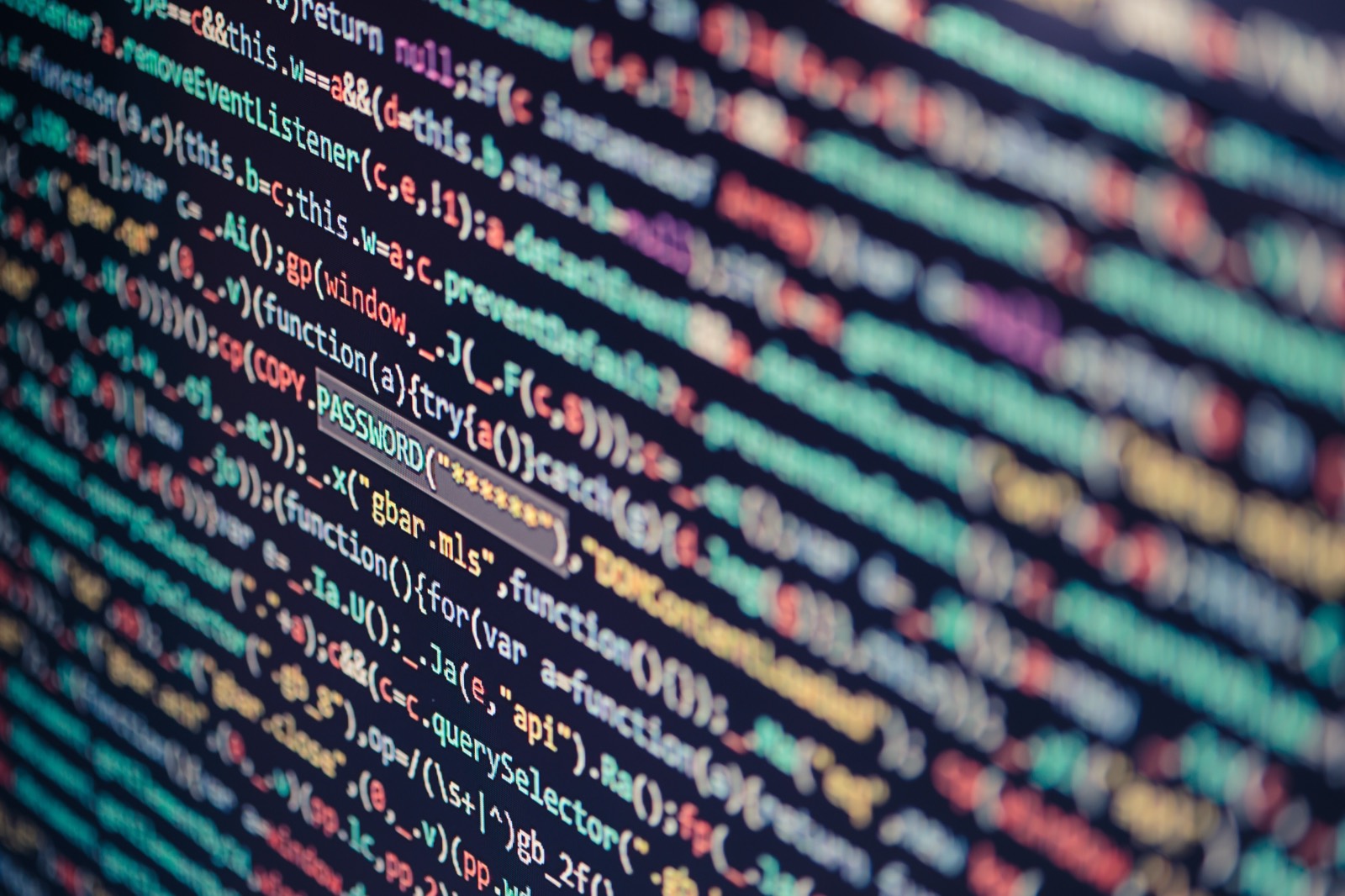Close-up of colorful program code on a dark screen